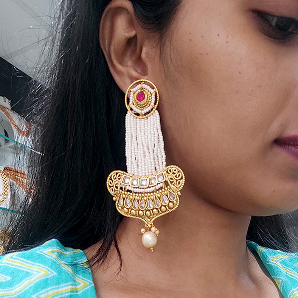 Intricately designed white stone earrings with maang tikka